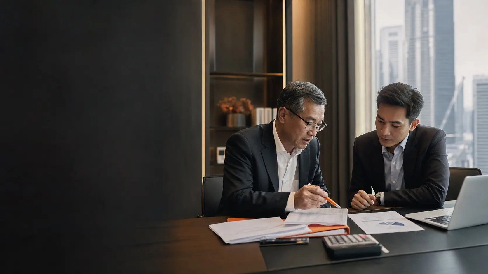Corporate tax advisor reviewing a Singapore tax computation with a business owner